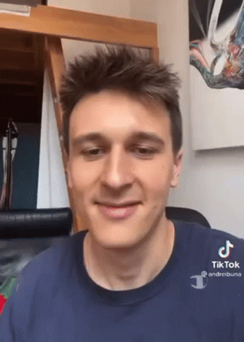 A Young Man Wearing A Blue Shirt That Says Tik Tok GIF