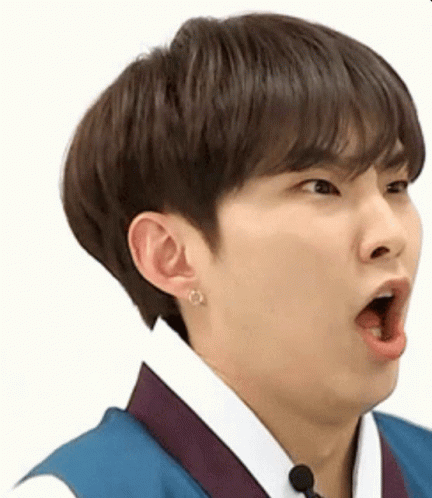 A Young Man Wearing A Blue Vest And A White Shirt Is Making A Funny Face With His Mouth Open . GIF