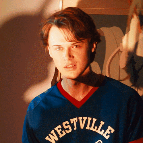 Young Man In Blue Westville Jersey Looking At Camera GIF