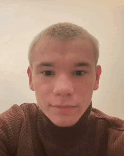A Young Man Wearing A Brown Turtleneck Sweater Is Taking A Selfie GIF