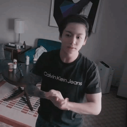 A Young Man Wearing A Calvin Klein Jeans Shirt GIF