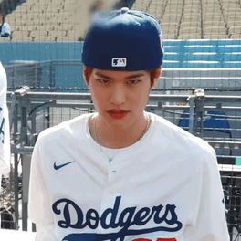 A Young Man Wearing A Dodgers Jersey And A Blue Hat GIF