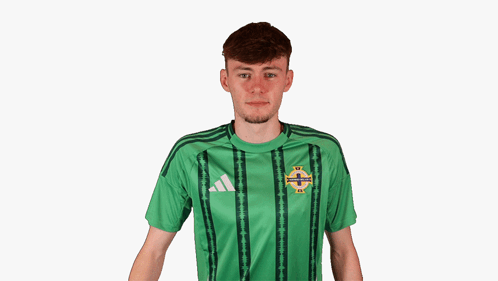 A Young Man Wearing A Green Adidas Shirt Covering His Ears GIF