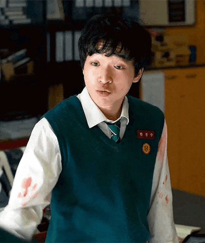 A Young Man Wearing A Green Vest And Tie Has Blood On His Sleeves GIF