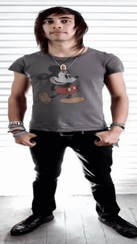 A Young Man Wearing A Grey Mickey Mouse Shirt GIF