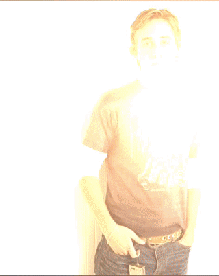 A Young Man Wearing A Harley Davidson T-Shirt Stands With His Hands In His Pockets GIF