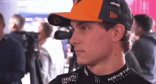 A Young Man Wearing A Hat And A Black Shirt With Monster Energy On It . GIF