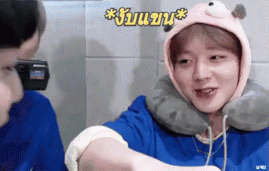 Young Men Talking With Hat And Neck Pillow GIF