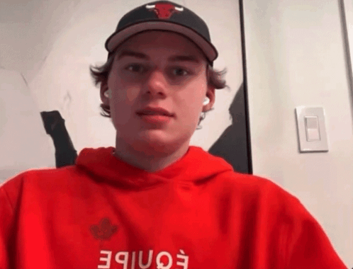 A Young Man Wearing A Hat And A Red Hoodie With The Word Eonibe On It GIF