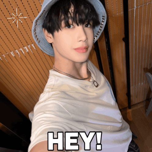 A Young Man Wearing A Hat And A White Shirt Says " Hey " GIF
