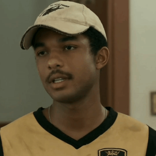 A Young Man Wearing A Hat That Says ' All You Hawk ' On It GIF