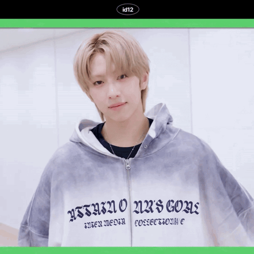 A Young Man Wearing A Hoodie That Says Id12 Holds A Red Rose In His Hand GIF