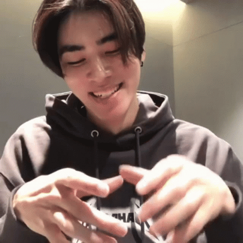 A Young Man Wearing A Hoodie With The Letter N On It GIF