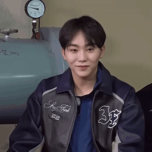 A Young Man Wearing A Jacket That Says New York GIF
