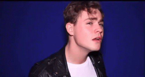A Young Man Wearing A Leather Jacket And White Shirt GIF