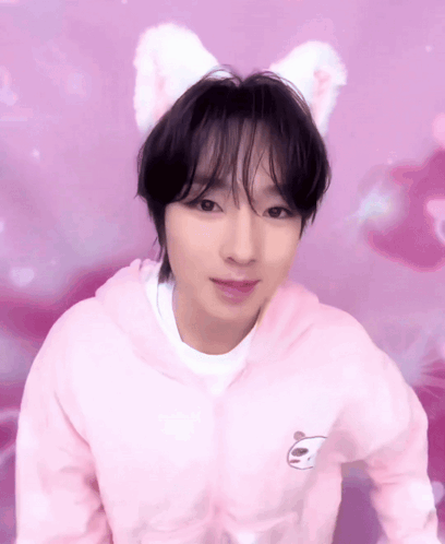 A Young Man Wearing A Pink Hoodie With A Panda On It GIF