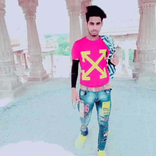 A Young Man Wearing A Pink T-Shirt With Arrows On It GIF