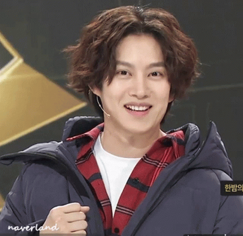 A Young Man Wearing A Plaid Shirt And A Blue Jacket Has Neverland Written On The Bottom Of His Jacket GIF