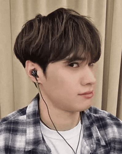 A Young Man Wearing A Plaid Shirt And Headphones GIF
