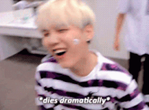 A Young Man Wearing A Purple And White Striped Shirt Is Laughing And Says `` Dies Dramatically '' . GIF