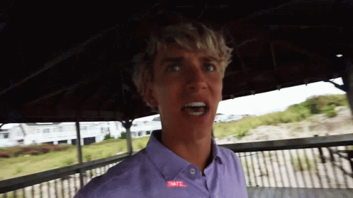 A Young Man Wearing A Purple Shirt With The Word Tnt On It GIF