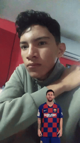 A Young Man Wearing A Rakuten Shirt Looks At The Camera GIF