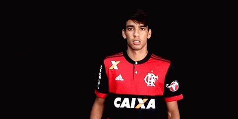 a young man wearing a red and black soccer jersey with the word caixa on it .