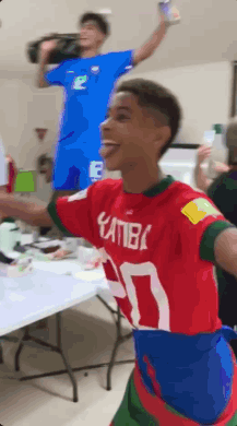 A Young Man Wearing A Red And Blue Shirt With The Number 30 On It GIF