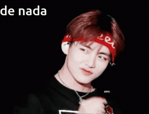 A Young Man Wearing A Red Bandana And A Necklace Is Making A Heart Shape With His Finger GIF