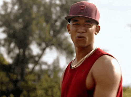 A Young Man Wearing A Red Hat With The Letter B On It GIF