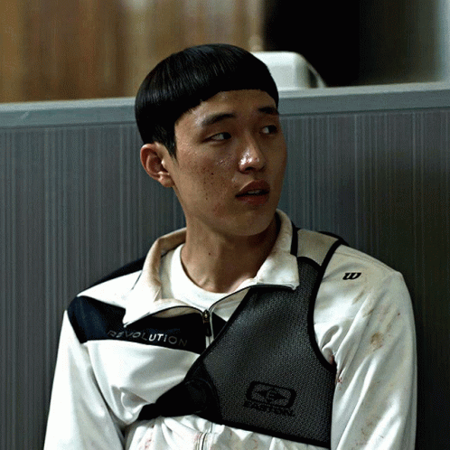 A Young Man Wearing A Revolution Jacket Sits In A Cubicle GIF