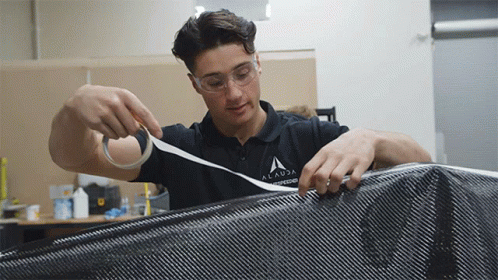 A Young Man Wearing A Shirt That Says Alanda Engineering GIF