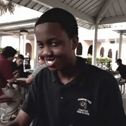 A Young Man Wearing A Shirt That Says Charter High School On It GIF