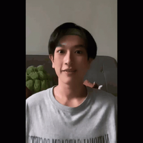 A Young Man Wearing A T-Shirt That Says ' Hollywood Mountain ' On It GIF