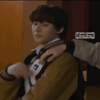A Young Man Wearing A Varsity Jacket With The Letter R On It Is Sitting In A Chair . GIF