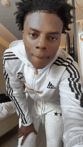 a young man wearing a white adidas hoodie