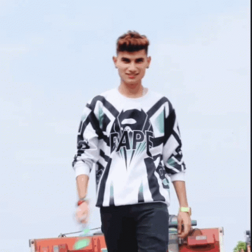 A Young Man Wearing A White And Black Shirt With The Word Ape On The Front GIF