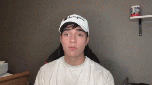 A Young Man Wearing A White Champion Hat GIF