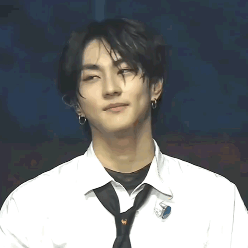 A Young Man Wearing A White Shirt And A Black Tie With A Pin That Says ' S ' On It GIF