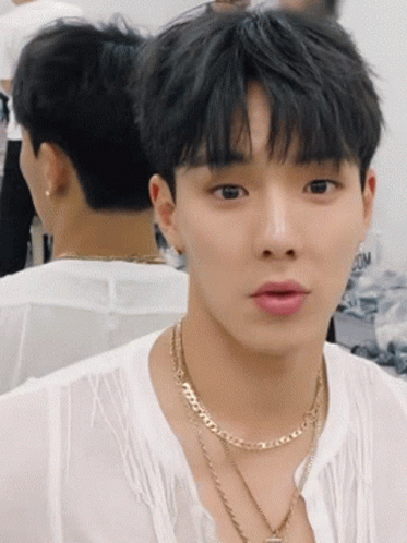 A Young Man Wearing A White Shirt And A Gold Necklace GIF