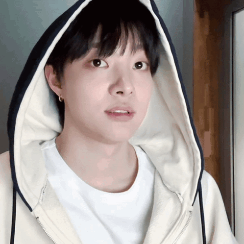 A Young Man Wearing A White Shirt And A Hooded Jacket GIF