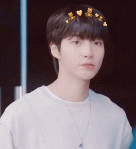 A Young Man Wearing A White Shirt And A Necklace With Teddy Bears On His Hair . GIF