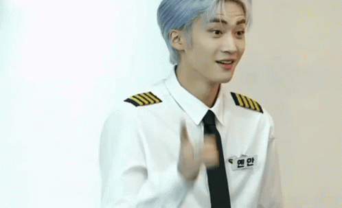 A Young Man Wearing A White Shirt And Black Tie Is Pointing GIF