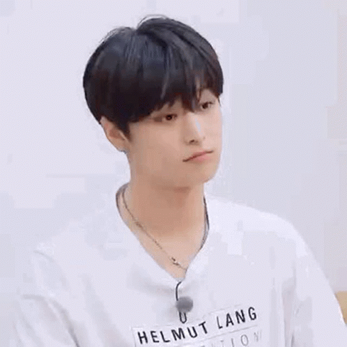 A Young Man Wearing A White T-Shirt And A Necklace . GIF