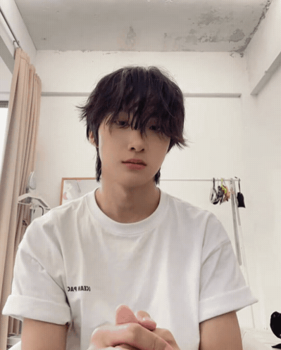 A Young Man Wearing A White T-Shirt That Says ' Iceberg ' On The Sleeve GIF