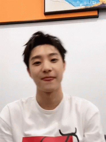 A Young Man Wearing A White T-Shirt With A Red Letter K On It GIF