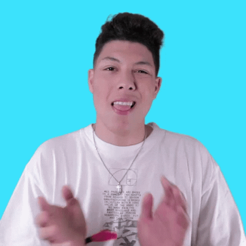 A Young Man Wearing A White T-Shirt With The Letter B On It Makes A Funny Face GIF
