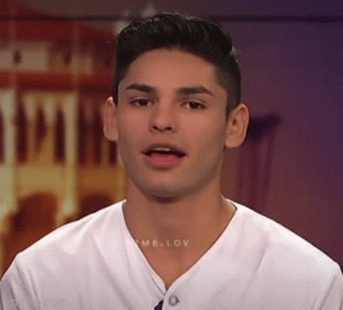 A Young Man Wearing A White T-Shirt With The Word Love On The Front GIF