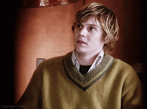A Young Man Wearing A Yellow Sweater With A Gray Stripe On The Collar GIF