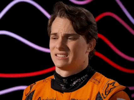 A Young Man Wearing An Orange Shirt With The Word Monster On The Collar GIF